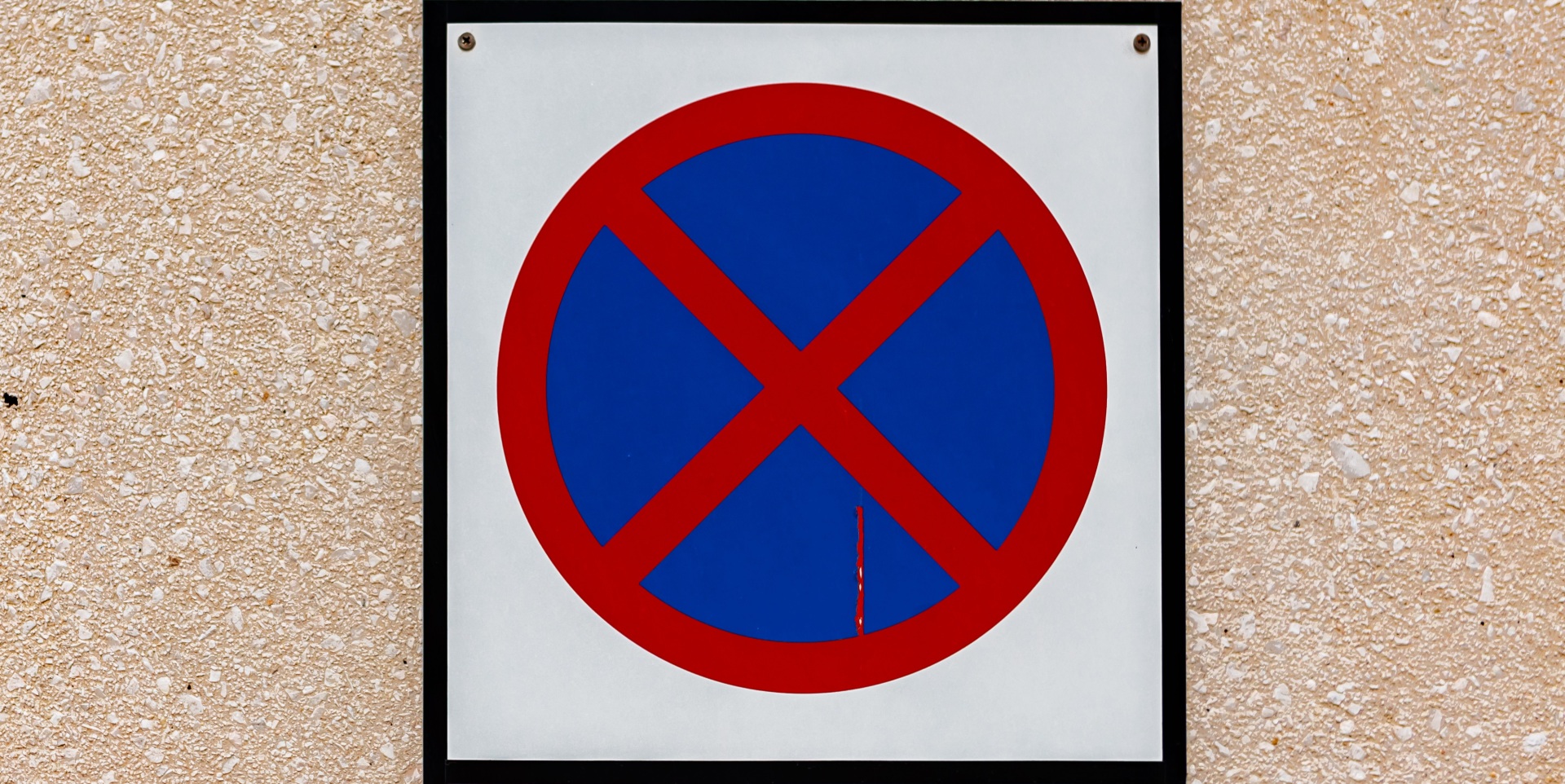 Stop and parking are prohibited sign on sand wall