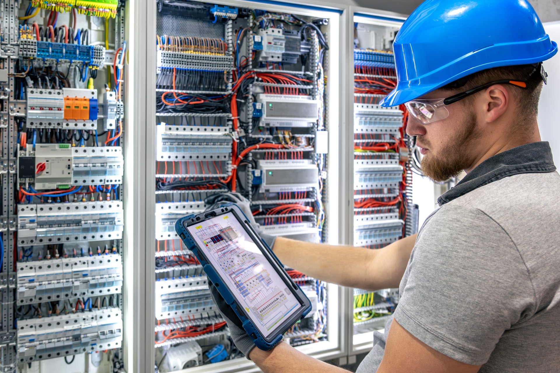 Electrician with tablet. Circuit inspection. Pre-installation check.